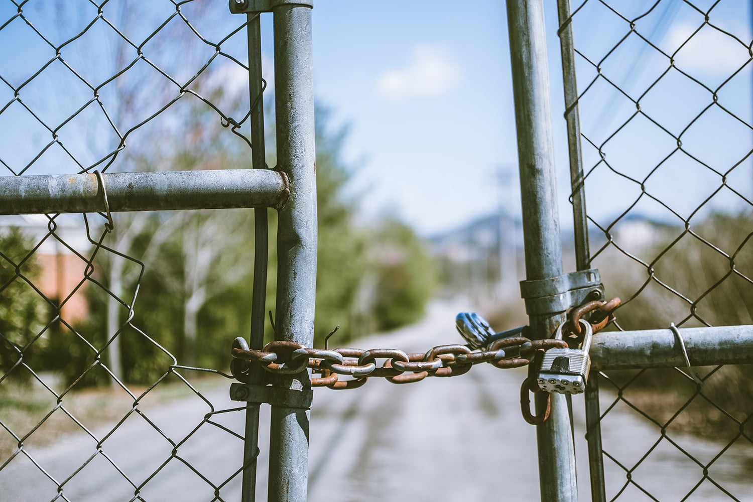A lock holding two sides of a gate together, representing the concept of gatekeeping.